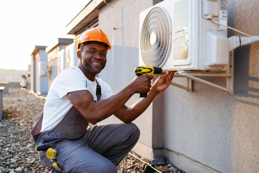 HVAC technician installing a new central air conditioner in St. Louis, MO