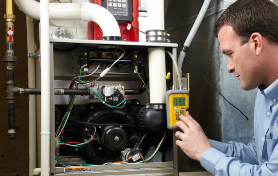 furnace-repair-st-louis-mo HVAC technician repairing a residential gas furnace in St. Louis, MO