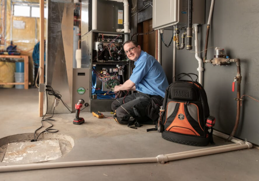 HVAC technician servicing a residential gas furnace in St. Louis, MO