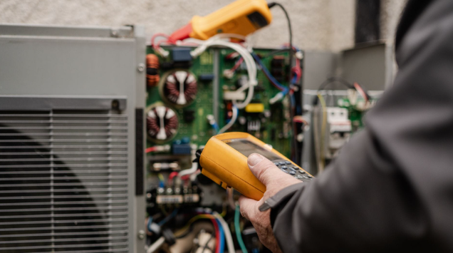 HVAC technician servicing a residential heat pump system in St. Louis, MO