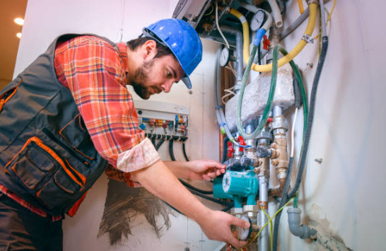 HVAC technician installing a new residential heating system in St. Louis, MO