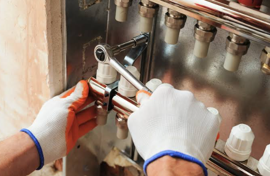 HVAC technician repairing a residential heating system in St. Louis, MO